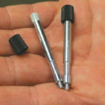 This plastic cap and metal screw will be ultrasonically welded together for use in computers; the machine can assemble about 40 units per minute.